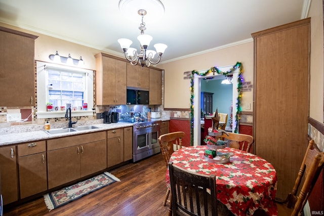 kitchen with dark wood-type flooring, sink, pendant lighting, double oven range, and a notable chandelier