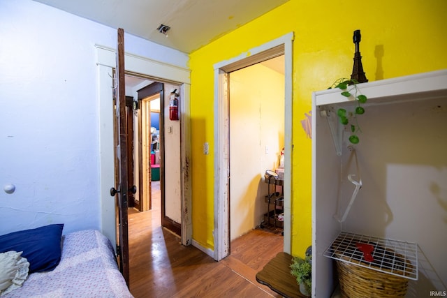 corridor with hardwood / wood-style floors