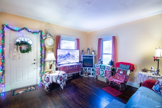 living room with crown molding, dark hardwood / wood-style flooring, and a textured ceiling