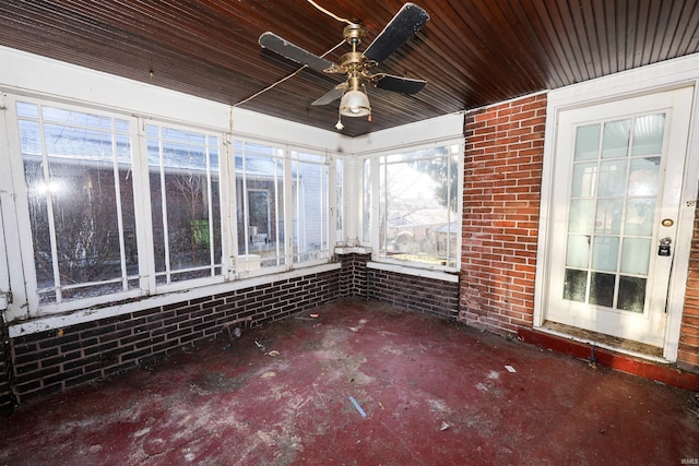 unfurnished sunroom with ceiling fan and wooden ceiling