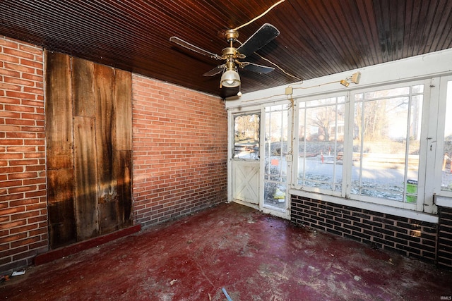 unfurnished sunroom featuring ceiling fan and wood ceiling