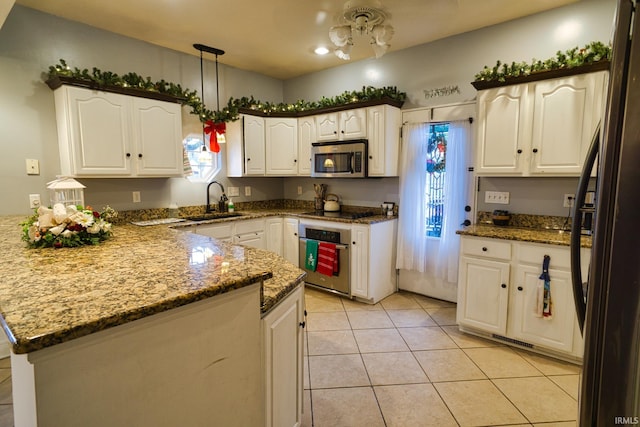 kitchen with sink, white cabinets, and appliances with stainless steel finishes