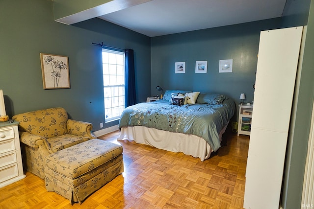 bedroom with light parquet flooring