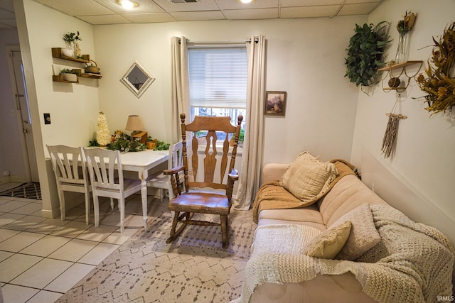 dining room featuring a drop ceiling and light tile patterned flooring