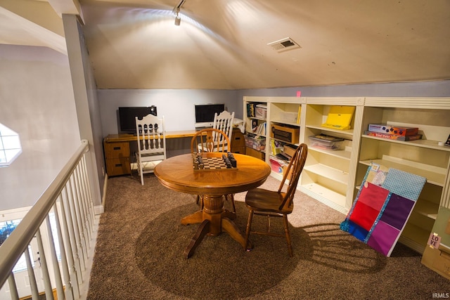 carpeted dining space featuring lofted ceiling