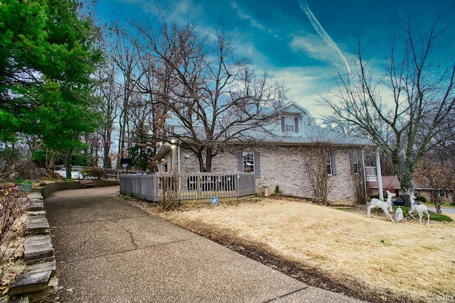 rear view of property featuring a wooden deck