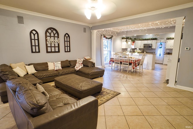 living room featuring light tile patterned floors and crown molding