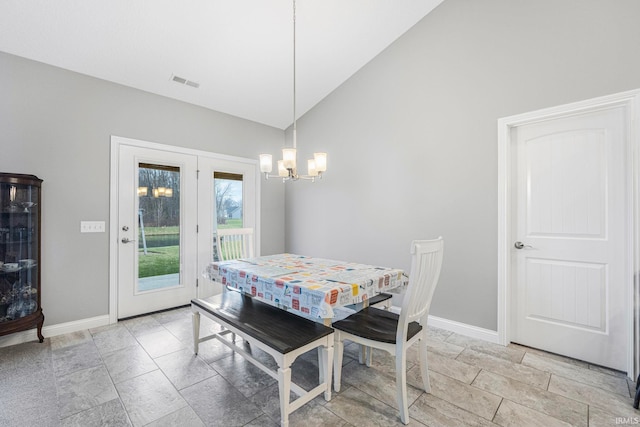 dining room featuring high vaulted ceiling and a notable chandelier