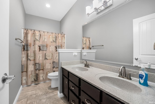 bathroom featuring a shower with curtain, vanity, and toilet