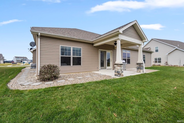 rear view of property with a lawn and a patio