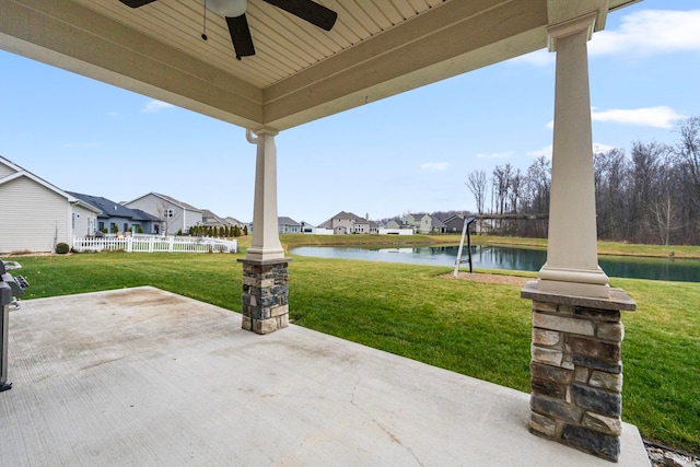 view of patio / terrace featuring a water view and ceiling fan