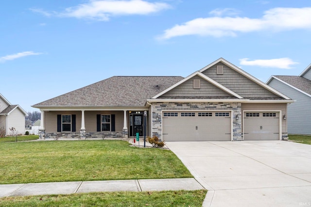 craftsman inspired home with covered porch, a garage, and a front lawn