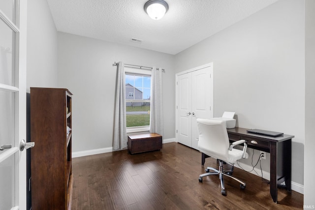 home office featuring dark hardwood / wood-style flooring and a textured ceiling