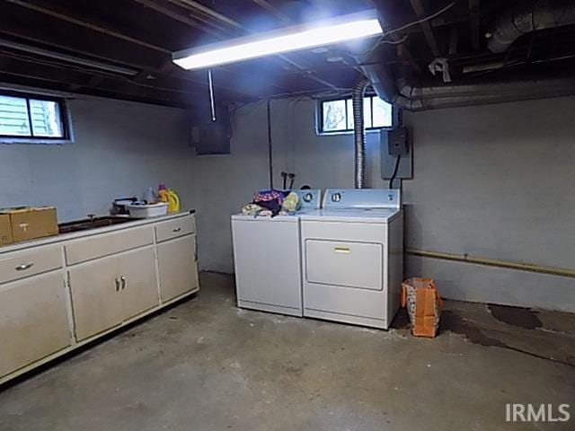 basement with washing machine and dryer and sink