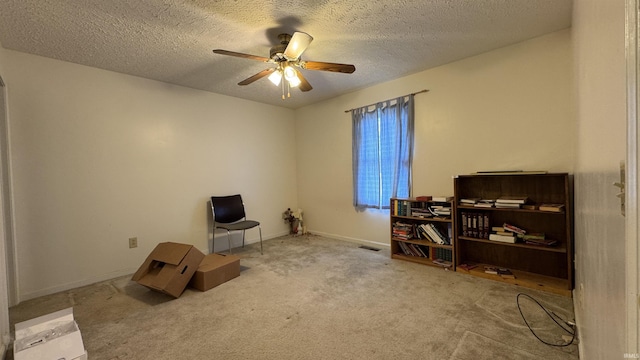 misc room featuring light colored carpet, a textured ceiling, and ceiling fan