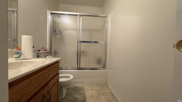 full bathroom with tile patterned floors, toilet, combined bath / shower with glass door, and vanity