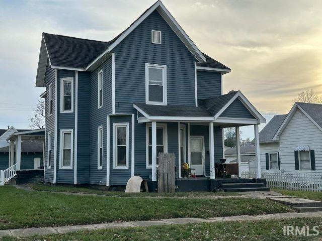 view of front of house with a lawn and covered porch