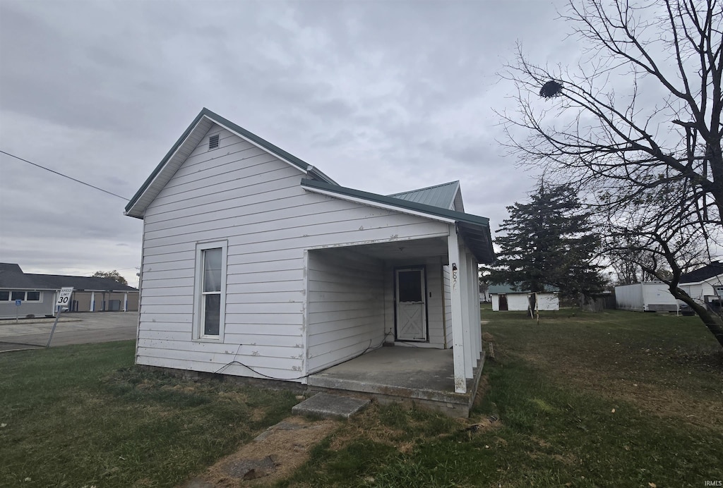 rear view of house with a yard