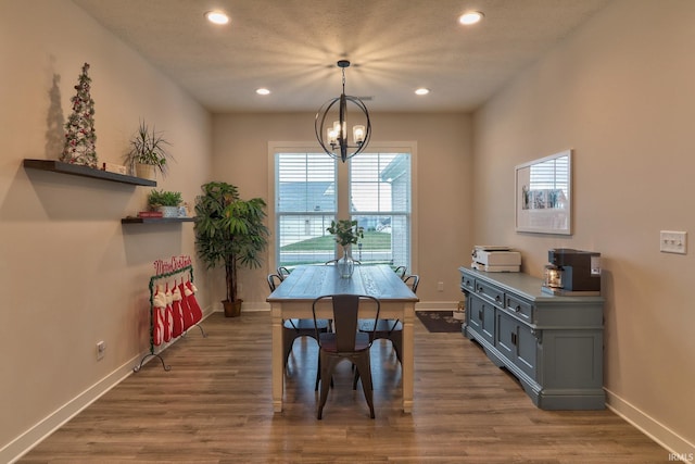 dining area with dark hardwood / wood-style flooring and a chandelier