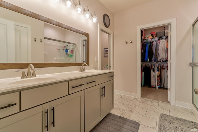 bathroom with a shower with door and vanity