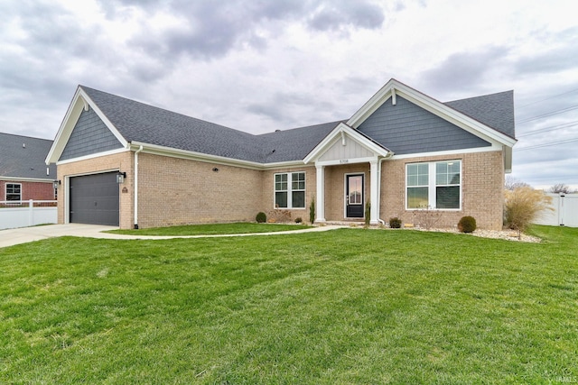 view of front of property with a front yard and a garage