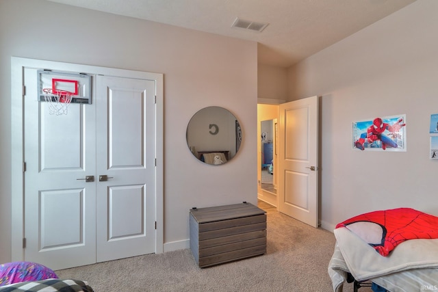 carpeted bedroom featuring a closet