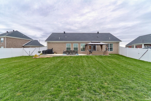 back of house featuring a gazebo, a patio area, and a yard