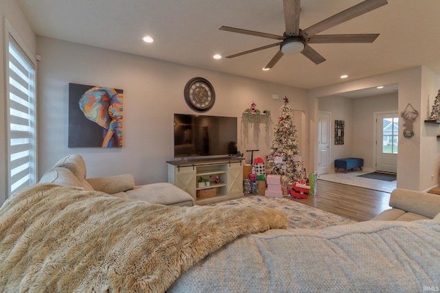 living room featuring hardwood / wood-style floors and ceiling fan