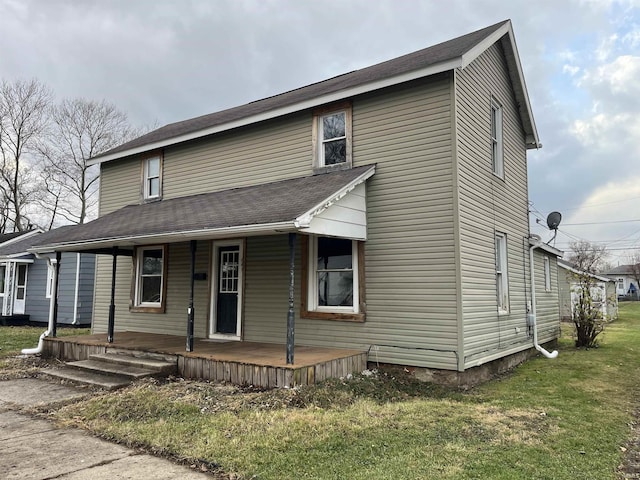 view of front facade featuring covered porch and a front yard