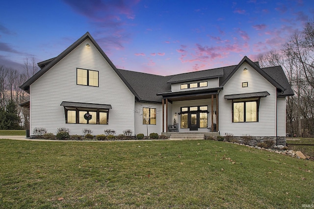 modern inspired farmhouse with covered porch and a yard