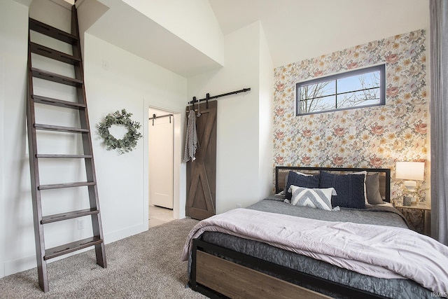 bedroom with a barn door, light colored carpet, and vaulted ceiling