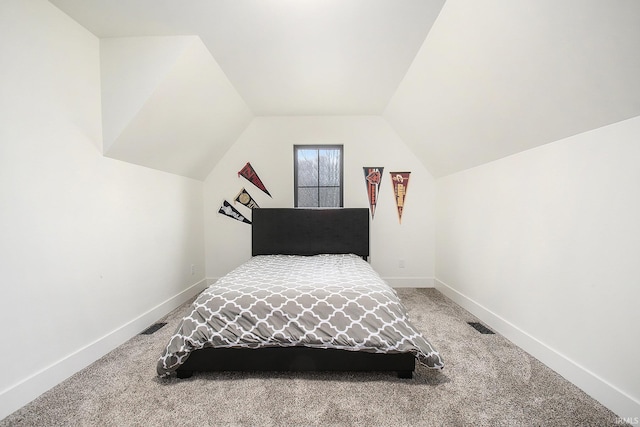 bedroom with lofted ceiling and carpet floors