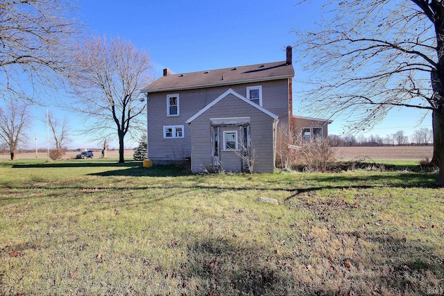 back of property with a lawn