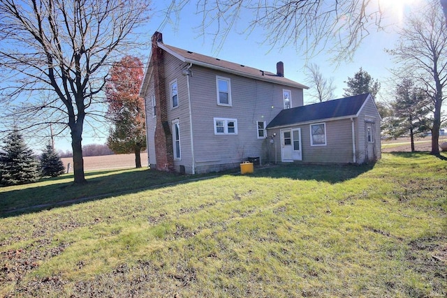 rear view of house with a lawn