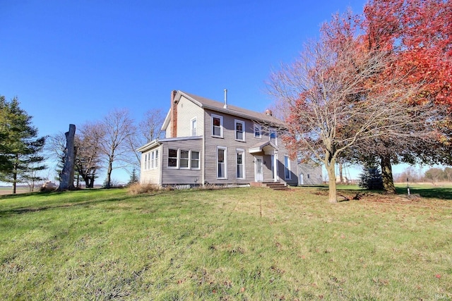 back of house with a yard