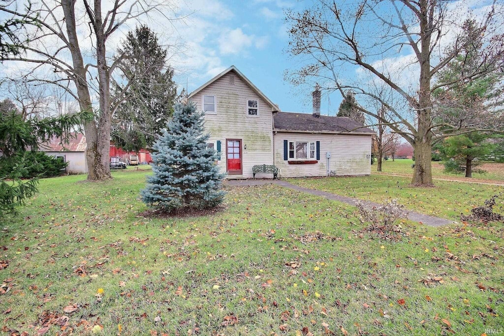 back of property featuring a lawn