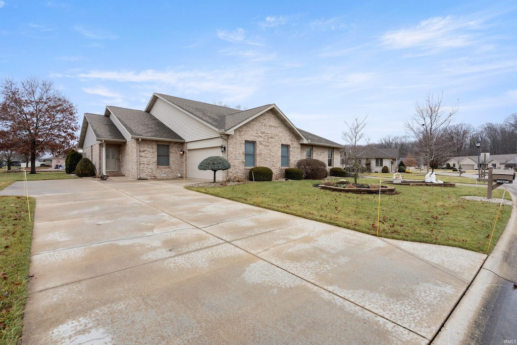 view of front of property with a front yard and a garage