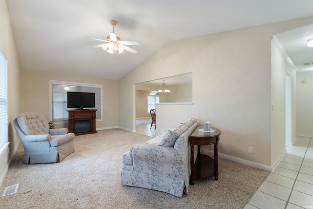 living room with light tile patterned floors, ceiling fan with notable chandelier, and lofted ceiling