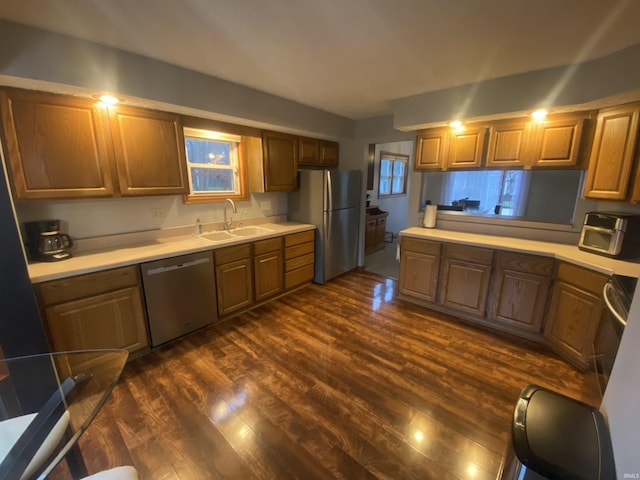 kitchen featuring sink, stainless steel appliances, and dark hardwood / wood-style floors