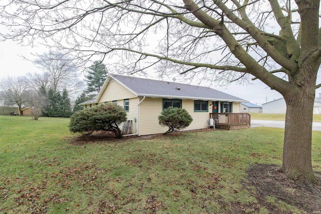 exterior space featuring a deck and a lawn