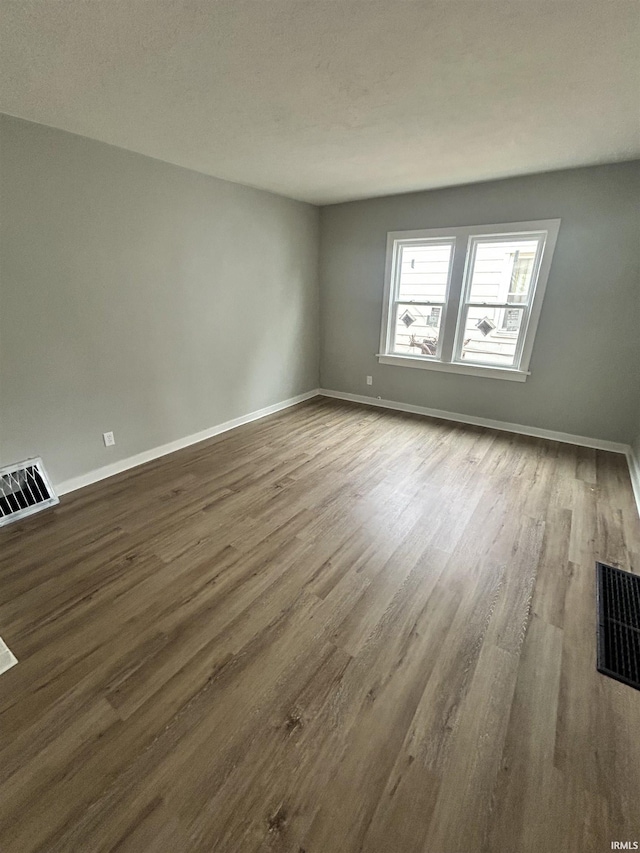 empty room with wood-type flooring