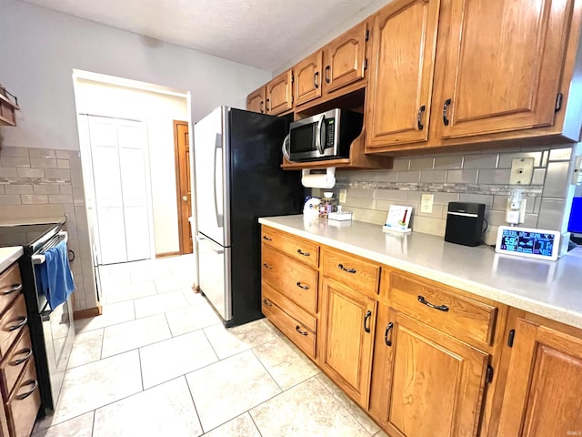 kitchen featuring light tile patterned floors and appliances with stainless steel finishes