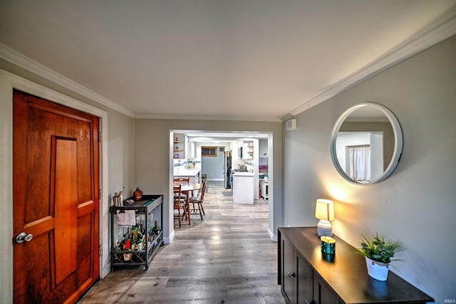 hall featuring crown molding and hardwood / wood-style floors