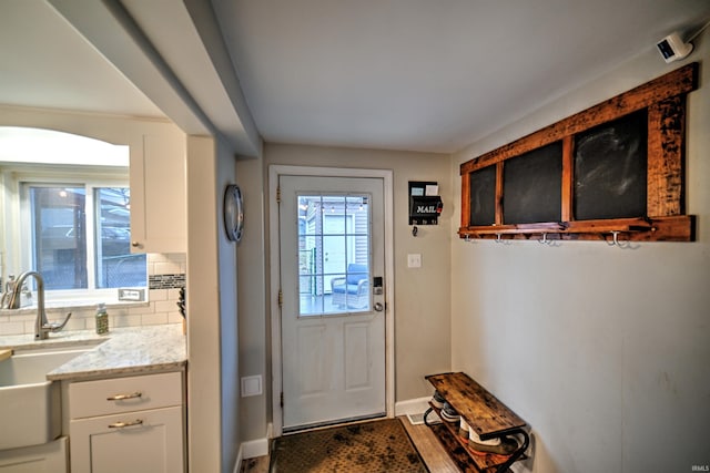 doorway to outside featuring sink