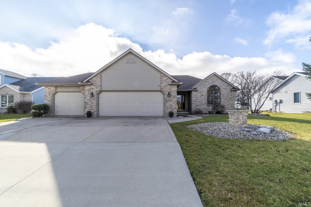 view of front of property featuring a front yard and a garage