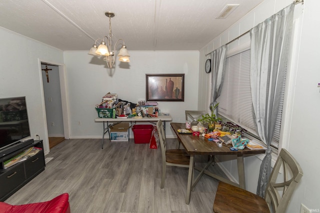 dining space featuring a notable chandelier and light hardwood / wood-style floors