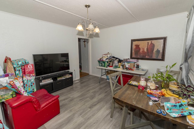 living room featuring a chandelier and wood-type flooring