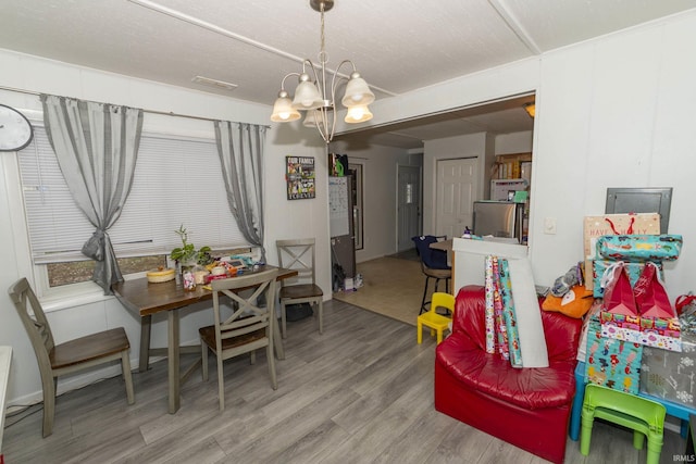 dining area with a chandelier and hardwood / wood-style flooring