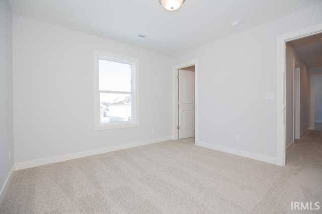 empty room featuring light colored carpet