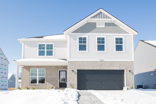 view of front of home with a garage and central AC unit